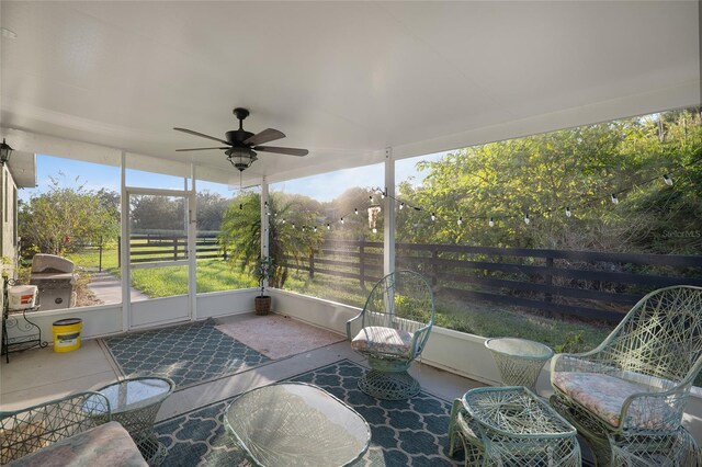 sunroom / solarium featuring ceiling fan and a wealth of natural light