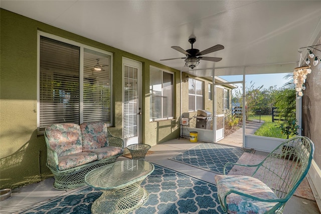 sunroom featuring ceiling fan