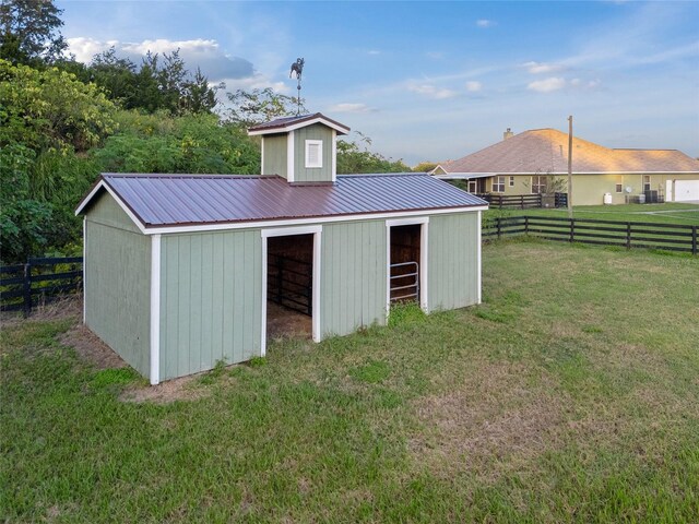 view of outbuilding featuring a yard