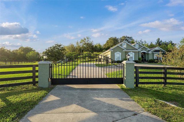 view of gate featuring a yard