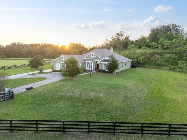 ranch-style house with a lawn and a rural view