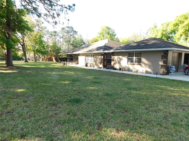 exterior space with a yard and a garage