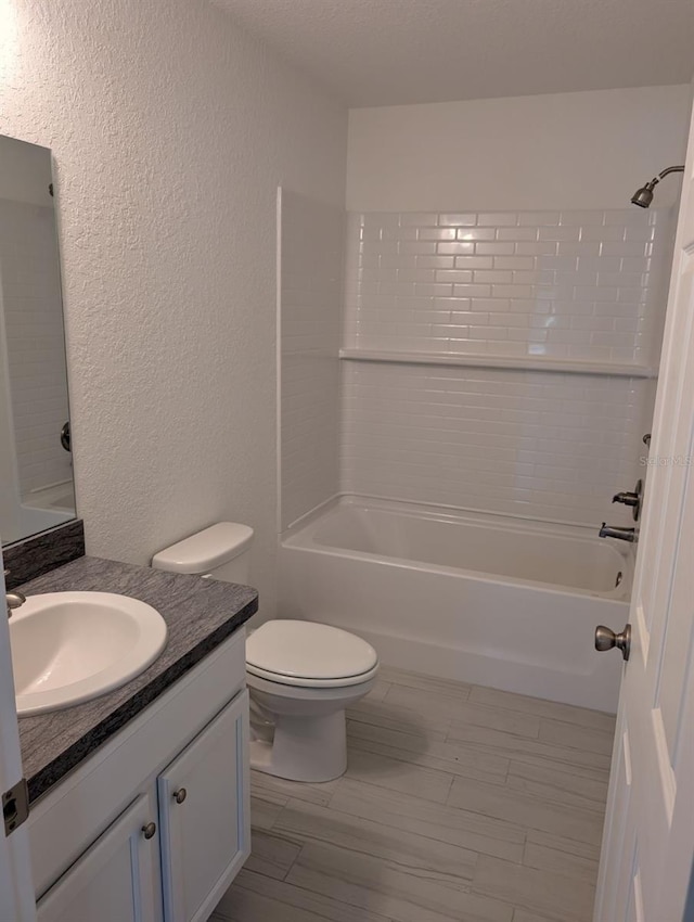 full bathroom with vanity, wood-type flooring, toilet, and shower / bathtub combination