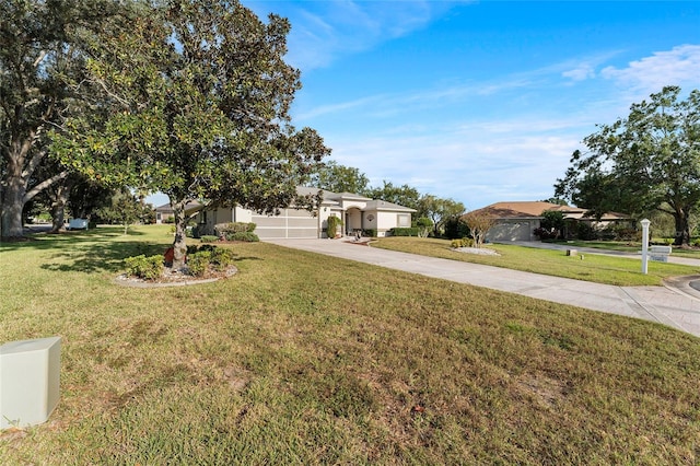 view of front of home with a front yard and a garage