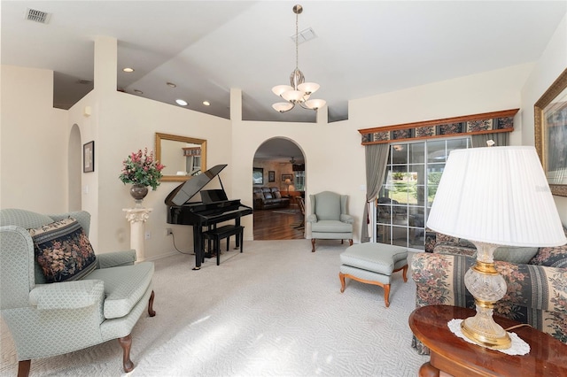 carpeted living room with lofted ceiling and a chandelier