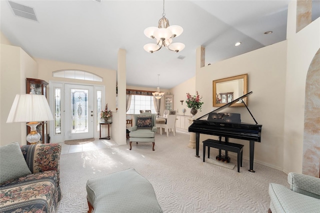 carpeted living room with a notable chandelier