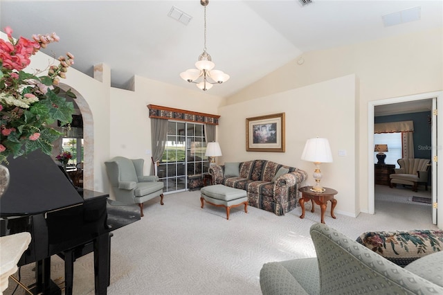 carpeted living room featuring vaulted ceiling and a chandelier