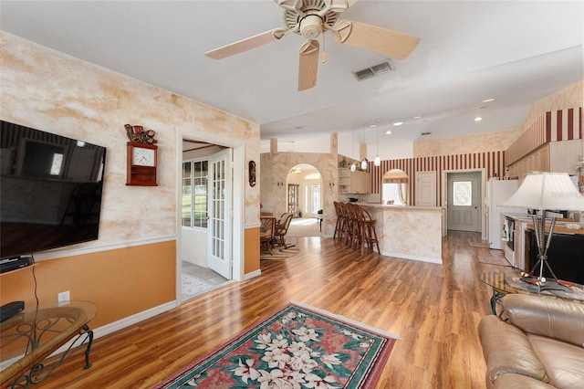 living room with ceiling fan and light hardwood / wood-style flooring