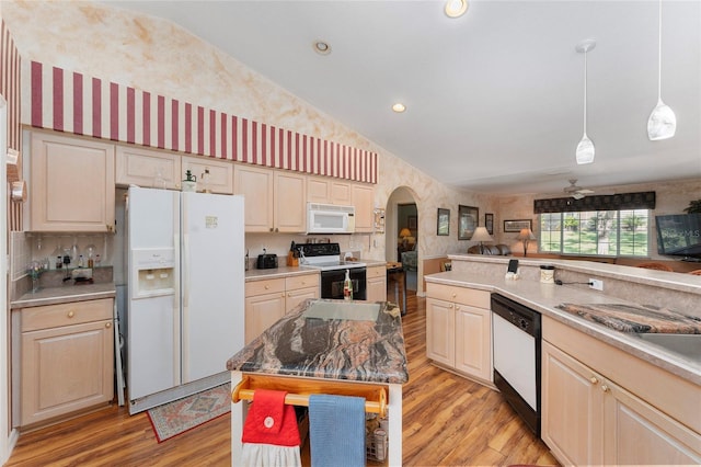 kitchen featuring light hardwood / wood-style floors, lofted ceiling, a center island, and white appliances