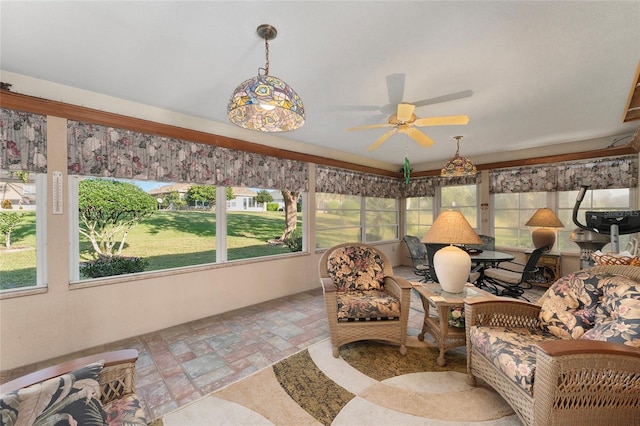 sunroom featuring ceiling fan