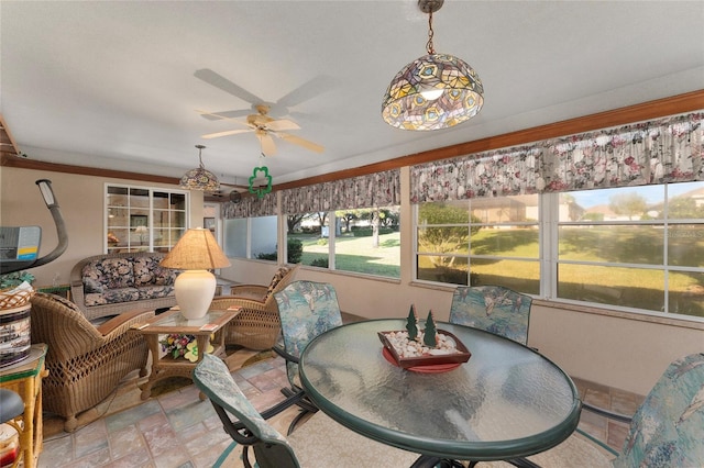 sunroom / solarium featuring ceiling fan