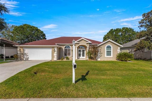 ranch-style house featuring a front yard and a garage