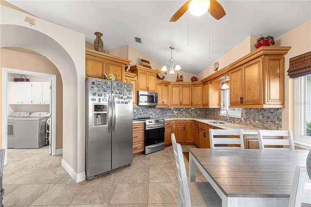 1960 NW 50th Cir, Ocala, FL 34482 - kitchen with stainless steel appliances, washer and clothes dryer, a sink, decorative backsplash, and a ceiling fan
