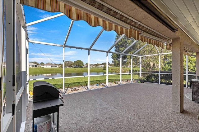 view of patio / terrace with a water view and glass enclosure