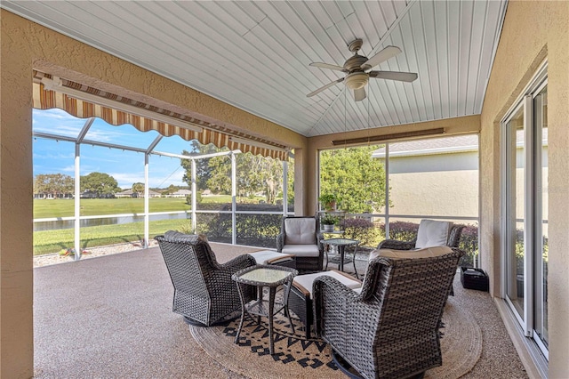 sunroom / solarium with a wealth of natural light, lofted ceiling, wood ceiling, and ceiling fan