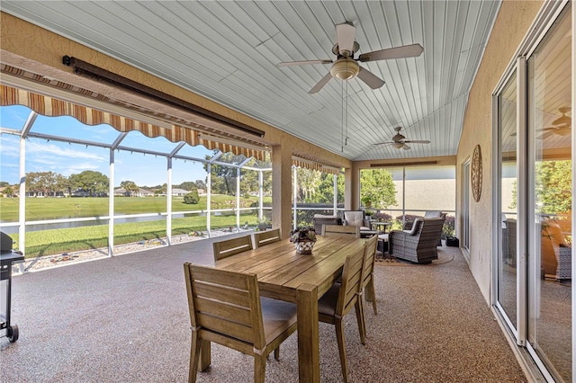 sunroom with lofted ceiling, wooden ceiling, and ceiling fan