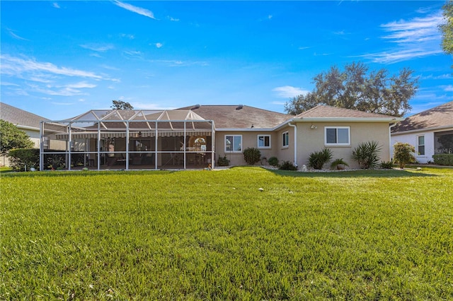 back of property featuring a lawn and a lanai