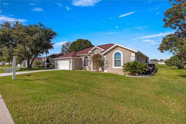 ranch-style house featuring a garage and a front lawn