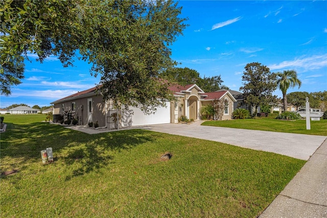 view of front of house with a garage and a front lawn