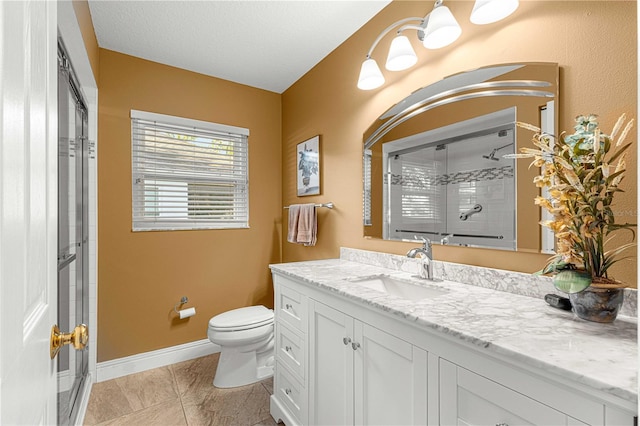 bathroom featuring a textured ceiling, a shower with shower door, toilet, vanity, and tile patterned flooring