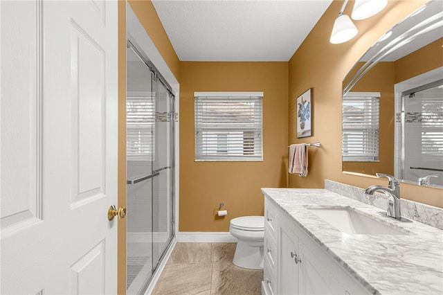 bathroom featuring tile patterned floors, toilet, vanity, a textured ceiling, and walk in shower