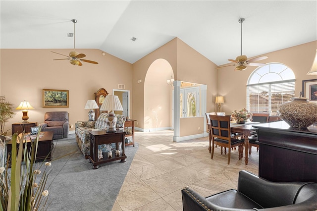 living room featuring light tile patterned flooring, high vaulted ceiling, and ceiling fan