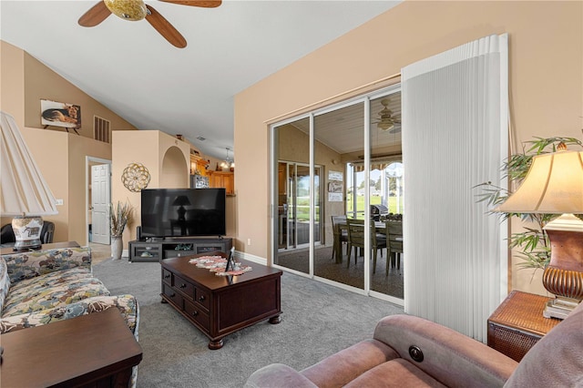 living room featuring vaulted ceiling, light carpet, and ceiling fan