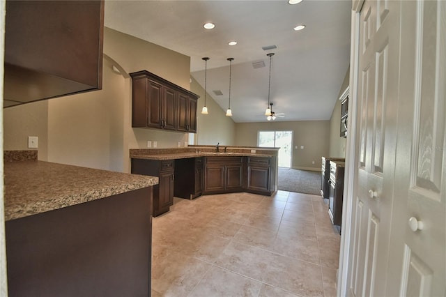 kitchen with kitchen peninsula, dark brown cabinets, vaulted ceiling, pendant lighting, and ceiling fan