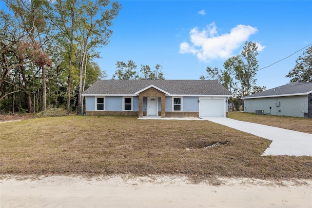 single story home featuring a front lawn and a garage