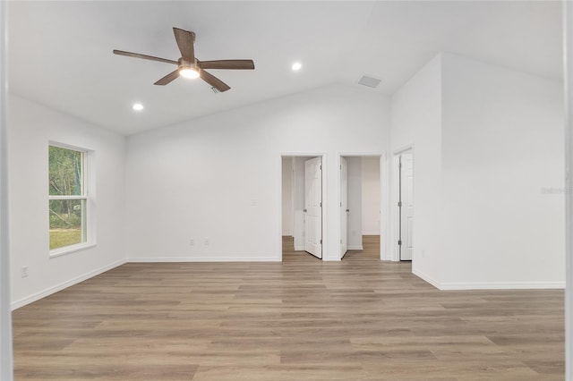 spare room with ceiling fan, vaulted ceiling, and light hardwood / wood-style floors