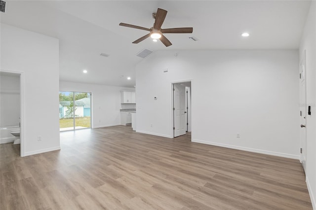 unfurnished living room with ceiling fan, vaulted ceiling, and light hardwood / wood-style flooring