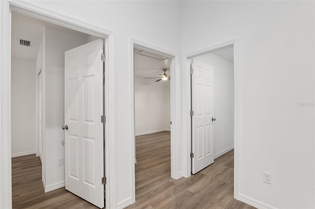 hallway with light hardwood / wood-style floors