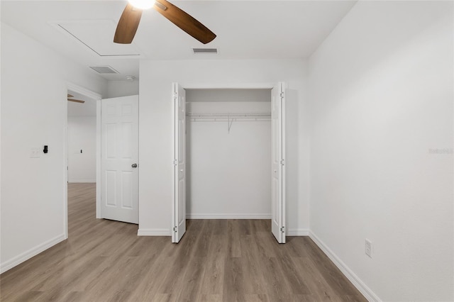 unfurnished bedroom with ceiling fan, a closet, and light hardwood / wood-style floors