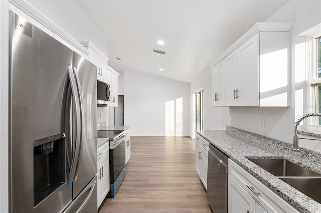 kitchen featuring stainless steel appliances, light hardwood / wood-style floors, white cabinets, and sink