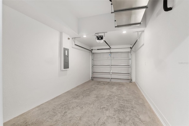 garage with a garage door opener and electric panel