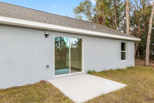 rear view of house featuring a yard and a patio