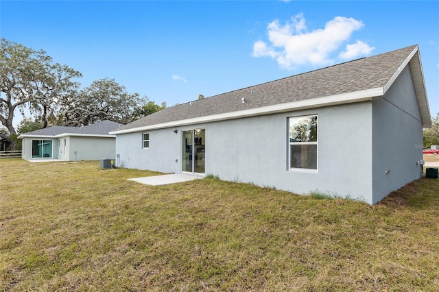 back of property with cooling unit and a lawn