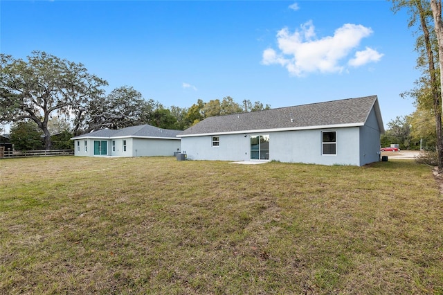 back of property with a lawn