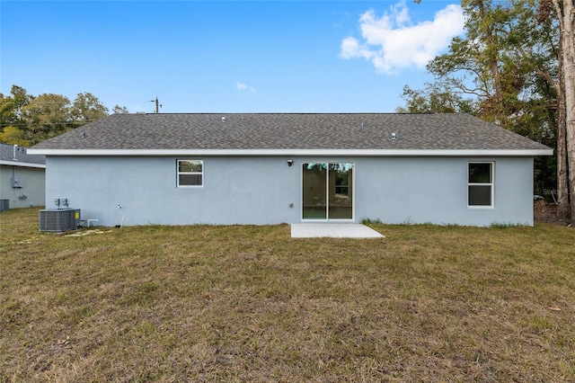 back of property with cooling unit and a lawn