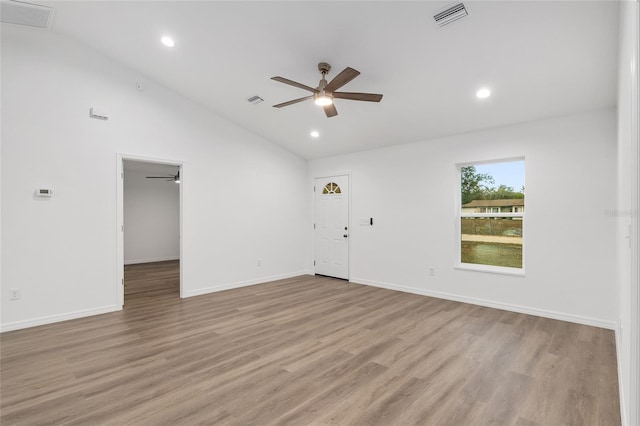 empty room featuring ceiling fan, light hardwood / wood-style flooring, and vaulted ceiling