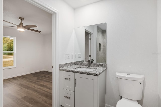 bathroom with ceiling fan, vanity, toilet, and hardwood / wood-style floors