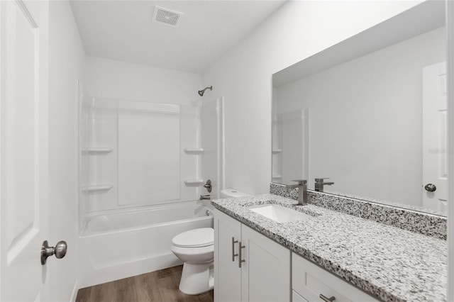 full bathroom with toilet, vanity,  shower combination, and hardwood / wood-style flooring