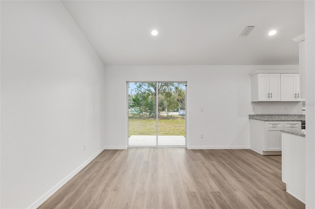 unfurnished living room with light hardwood / wood-style flooring