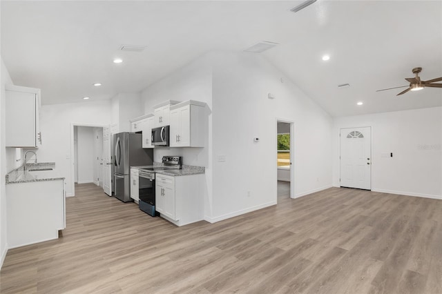 kitchen with light stone countertops, white cabinets, and stainless steel appliances