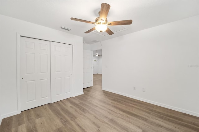 unfurnished bedroom featuring ceiling fan, hardwood / wood-style floors, and a closet