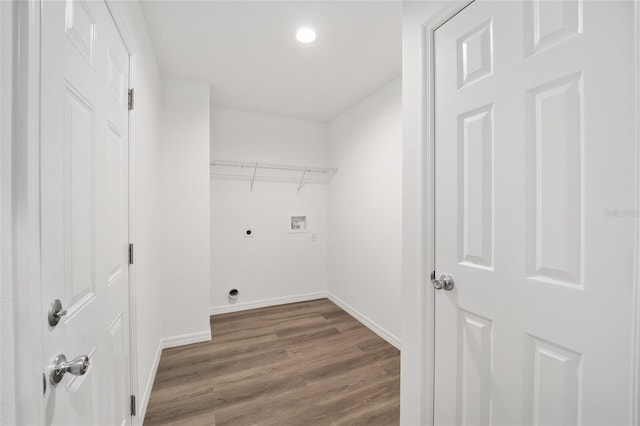 washroom featuring dark hardwood / wood-style floors, hookup for an electric dryer, and hookup for a washing machine