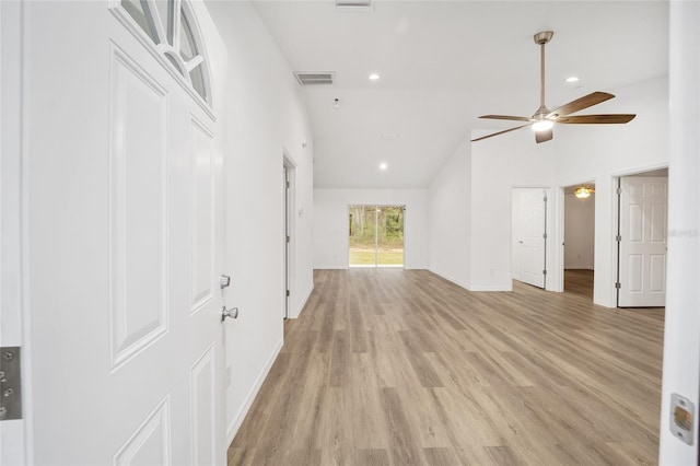 interior space with ceiling fan, high vaulted ceiling, and light wood-type flooring