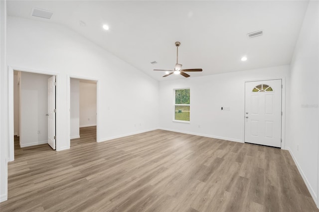 unfurnished living room featuring light wood-type flooring, ceiling fan, and high vaulted ceiling