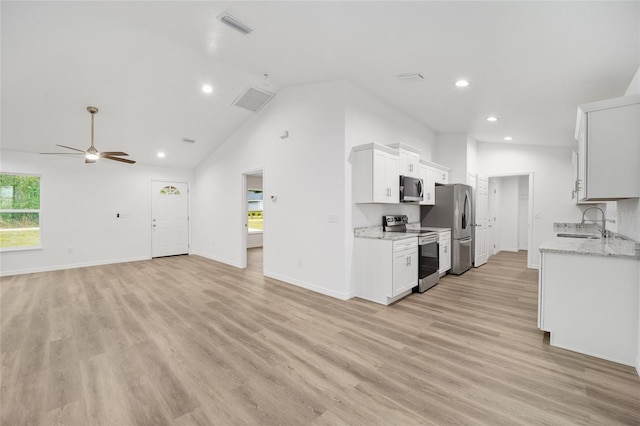 kitchen featuring ceiling fan, sink, white cabinetry, light stone countertops, and stainless steel appliances