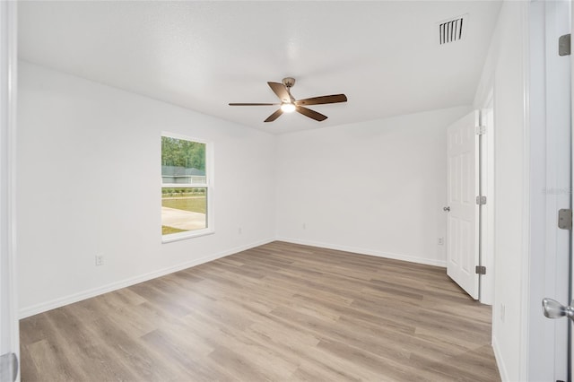 empty room with ceiling fan and light hardwood / wood-style flooring